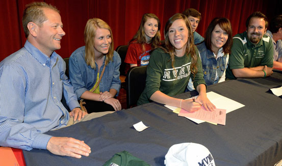 Bethany Bogantz (center in green) has signed to play for the Lady Cougars in 2013